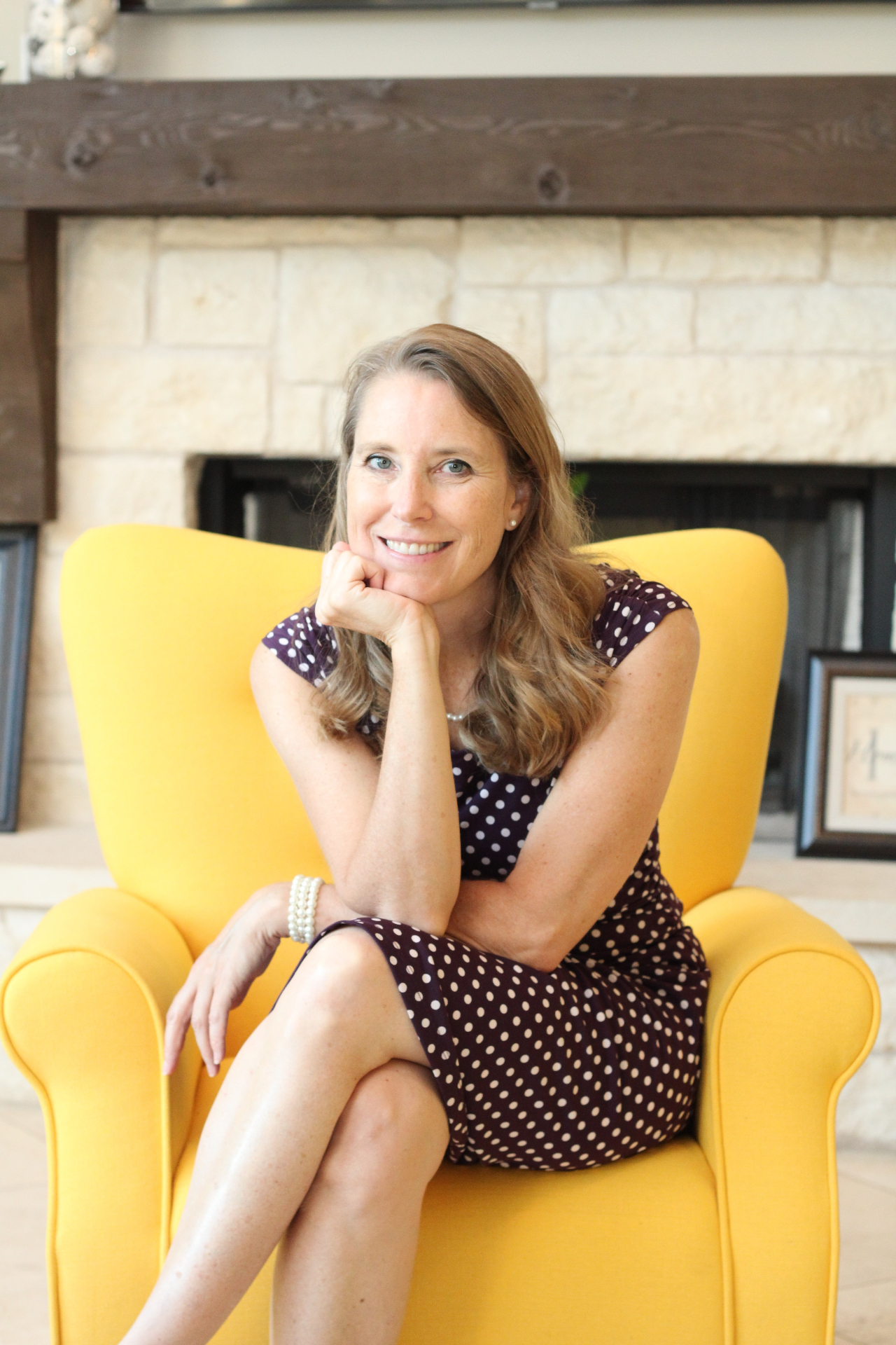 Dr. Sears seated in a yellow armchair